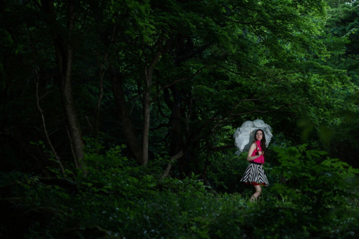 Example image of a woman in a forest with an umbrella