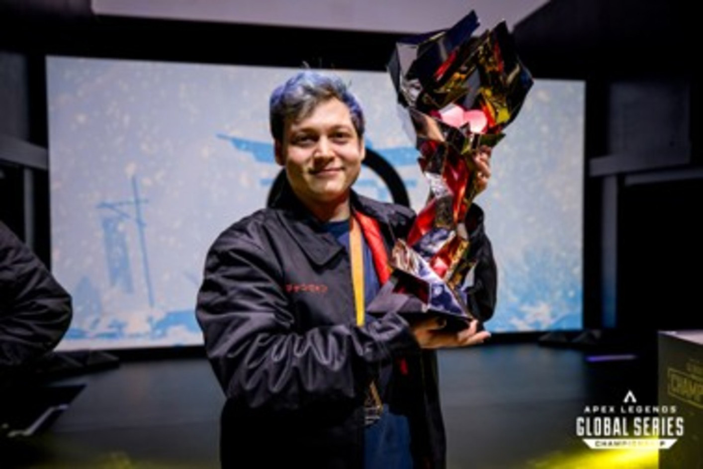 The player Monsoon from team Oblivion holding a trophy